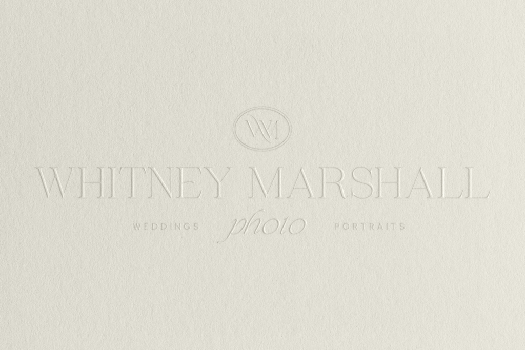 wedding photographer logo mockup of her main logo embossed on white cream paper