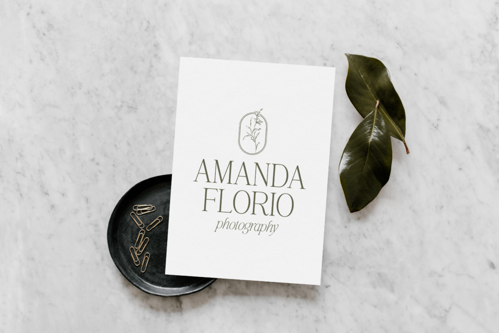 Wedding photographer logo mockup on a white paper with a marbled background