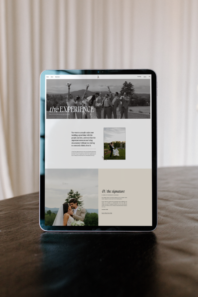 Mockup of wedding photography website on iPad sitting on table in front of drapes